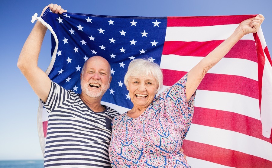 Senior couple holding american flag tagalog language